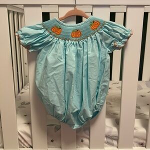 Light blue baby girls bubble onesie with pumpkin collar.